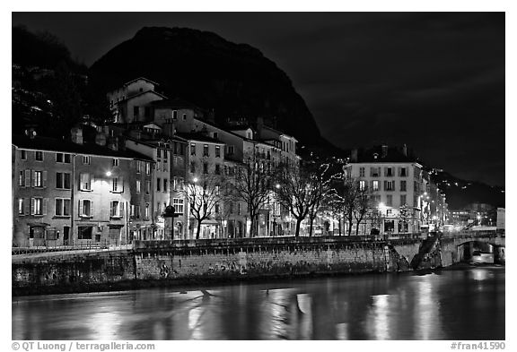 Isere River and houses below the Citadelle at night. Grenoble, France (black and white)