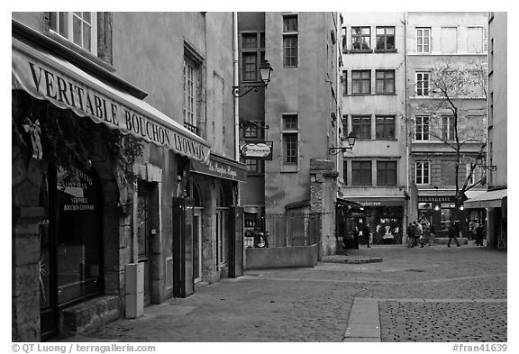 Square with restaurant offering the local specialty bouchon lyonnais. Lyon, France (black and white)