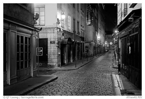 Narrow cobblestone street in historic district at night. Lyon, France