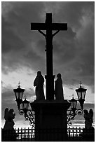 Cross and statues with sunset clouds. Avignon, Provence, France (black and white)