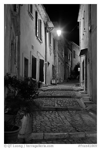 Cobblestone passageway with stepts at night. Arles, Provence, France (black and white)
