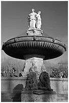 Monumental fountain with three statues representing art, justice and agriculture. Aix-en-Provence, France (black and white)