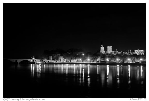 Avignon skyline at night with lights reflected in Rhone River. Avignon, Provence, France