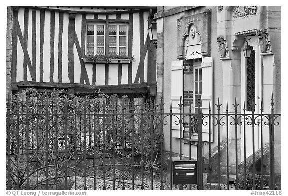 Fence, stone house, and half-timbered house, Provins. France (black and white)