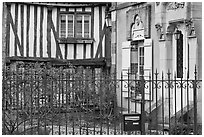 Fence, stone house, and half-timbered house, Provins. France ( black and white)