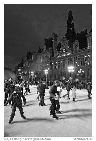 Holiday skaters, Hotel de Ville by night. Paris, France