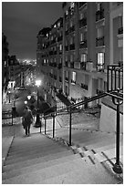 Woman on stairs by night, Montmartre. Paris, France (black and white)