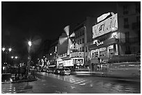 Boulevard by night with Moulin Rouge. Paris, France (black and white)