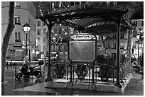 Subway entrance with art deco canopy by night. Paris, France (black and white)