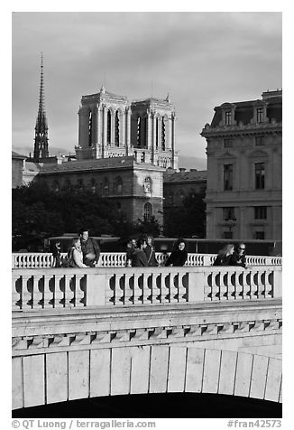Watching the sunset from a bridge, with Notre Dame towers behind. Paris, France (black and white)