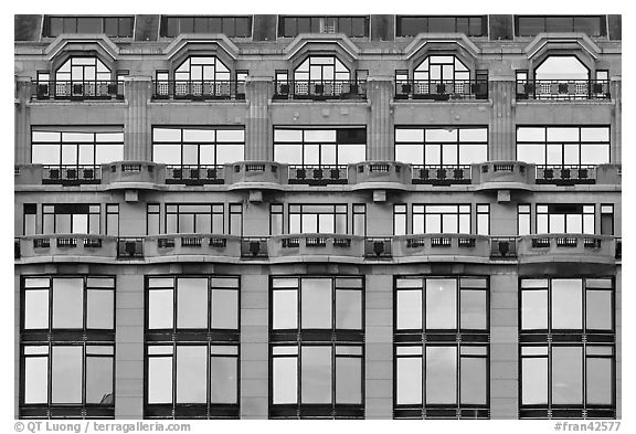 Glass windows of the Samaritaine reflecting colors of sunset. Paris, France (black and white)