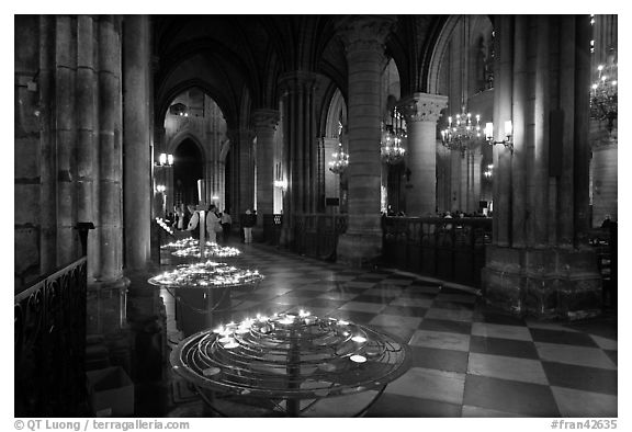 North Aisle and candles, cathedral Notre-Dame-de-Paris. Paris, France (black and white)