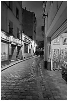 Pedestrian cobblestone street and tourist business, Montmartre. Paris, France (black and white)