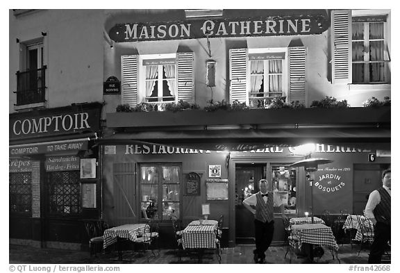 Restaurant and waiter at night, Montmartre. Paris, France (black and white)
