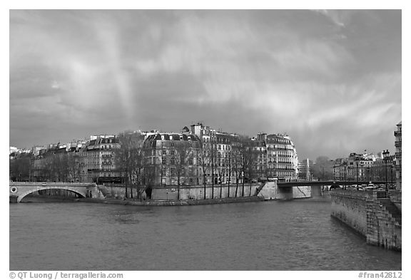 Clearing storm with rainbow above Saint Louis Island. Paris, France (black and white)