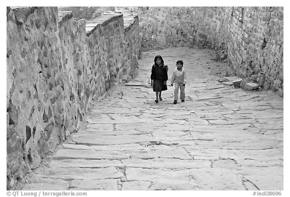 Children walking on the stone ramp leading to the fort. Jodhpur, Rajasthan, India