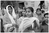 Women standing in the street during a wedding. Jodhpur, Rajasthan, India (black and white)