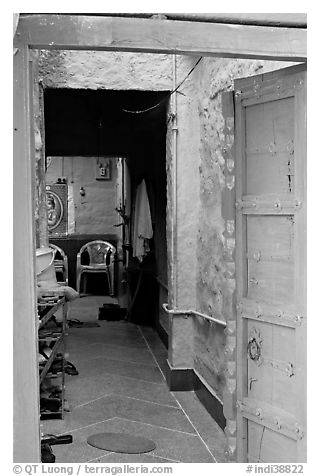 Doorway and inside of a house painted blue. Jodhpur, Rajasthan, India (black and white)