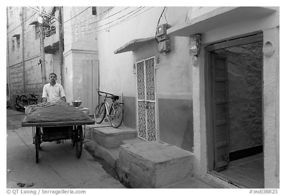 Man with vegetables car in front of painted house. Jodhpur, Rajasthan, India