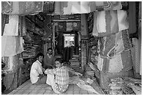 Men in shop selling colorful fabrics, Sardar market. Jodhpur, Rajasthan, India ( black and white)
