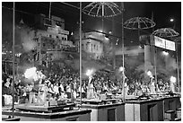Pujari (priests) performing arti ceremony in front of large attendance. Varanasi, Uttar Pradesh, India (black and white)