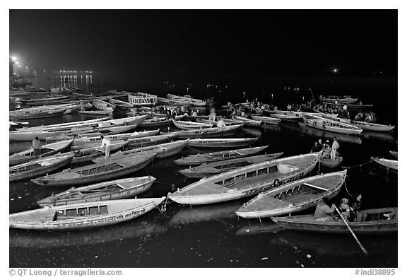 Boats on the Ganges River at night during arti ceremony. Varanasi, Uttar Pradesh, India (black and white)