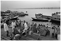 Men preparing for ritual bath on banks of Ganges River at dawn. Varanasi, Uttar Pradesh, India (black and white)