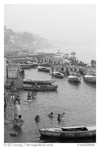 Pilgrims taking a holy dip in the Ganga River at dawn. Varanasi, Uttar Pradesh, India (black and white)