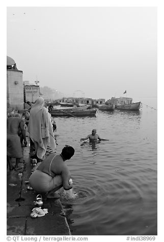 Hindu men dipping in the Ganges River at dawn. Varanasi, Uttar Pradesh, India (black and white)