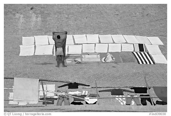 Man laying out laundry for drying. Varanasi, Uttar Pradesh, India (black and white)