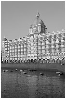 Taj Mahal Palace Hotel and small boats in harbor. Mumbai, Maharashtra, India (black and white)