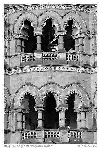 Facade with woman at window, Chhatrapati Shivaji Terminus. Mumbai, Maharashtra, India (black and white)