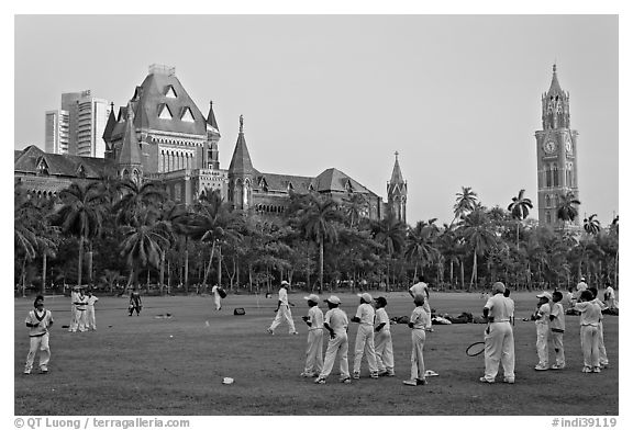 Boys in cricket attire on Oval Maidan, High Court, and Rajabai Tower. Mumbai, Maharashtra, India (black and white)