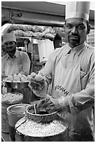 Cooks in food stall, Chowpatty Beach. Mumbai, Maharashtra, India (black and white)