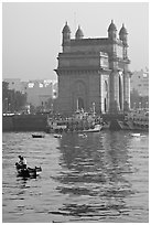 Small boat and Gateway of India, early morning. Mumbai, Maharashtra, India (black and white)