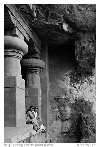 Women sitting at entrance of cave, Elephanta Island. Mumbai, Maharashtra, India (black and white)