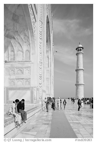 Couple sitting on side pishtaq and tourists strolling on platform, Taj Mahal. Agra, Uttar Pradesh, India (black and white)