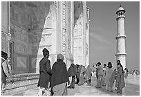Colorful tourists on the platform, Taj Mahal,. Agra, Uttar Pradesh, India (black and white)