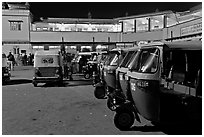 Auto-rickshaws in front of train station. Agra, Uttar Pradesh, India ( black and white)