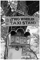 Two wheeler taxi stand and altar on tree. Goa, India (black and white)