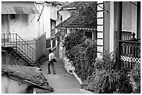 Man in alley with gardens, Panjim. Goa, India ( black and white)