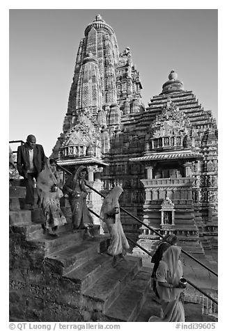 Worshipers going down stairs in front of Lakshmana temple. Khajuraho, Madhya Pradesh, India (black and white)