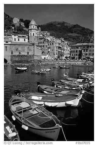 Colorful samll fishing boats in the harbor and main plaza, Vernazza. Cinque Terre, Liguria, Italy