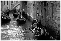 Several gondolas in a narrow canal. Venice, Veneto, Italy ( black and white)