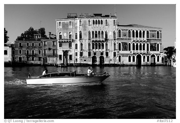 Water taxi passes in front of the Palazzo Dorio on the Grand Canal. Venice, Veneto, Italy (black and white)
