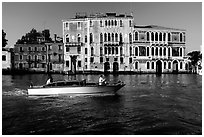 Water taxi passes in front of the Palazzo Dorio on the Grand Canal. Venice, Veneto, Italy ( black and white)