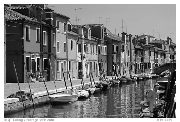 Canal lined with typical brightly painted houses, Burano. Venice, Veneto, Italy (black and white)