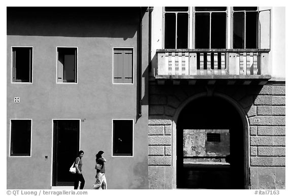 House facades with women walking. Veneto, Italy (black and white)