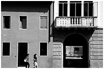 House facades with women walking. Veneto, Italy ( black and white)