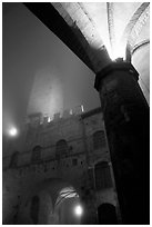 Medieval towers above Piazza del Duomo, foggy night. San Gimignano, Tuscany, Italy (black and white)
